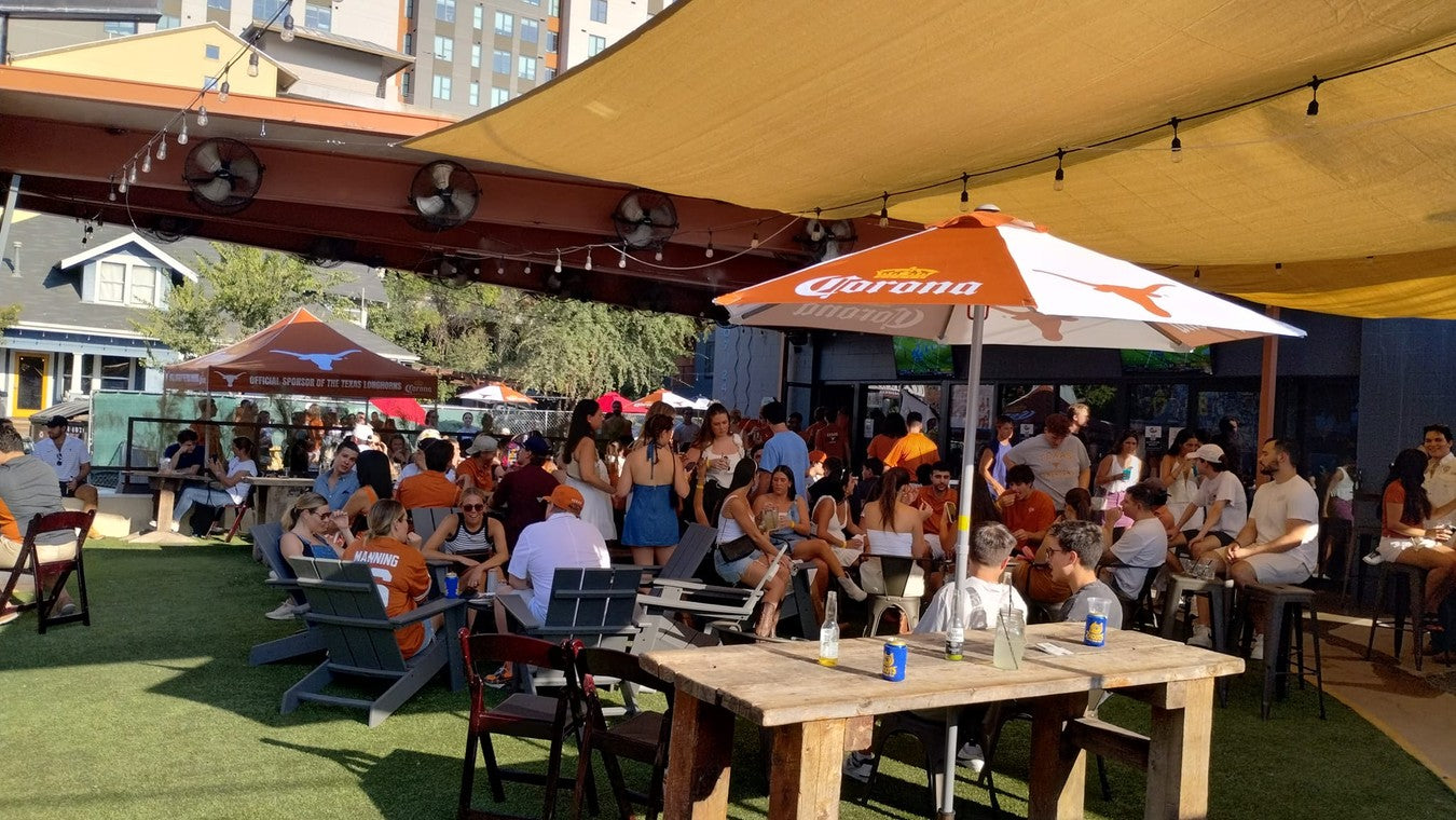 Packed patio on a Texas football game day, orange and white everywhere