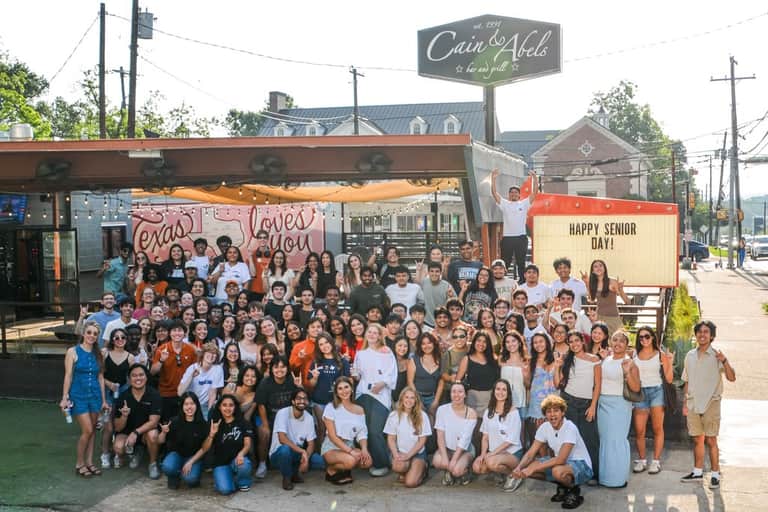 Around eighty regulars packed in front of the bar for Senior Day, a HAPPY SENIOR DAY marquee behind them